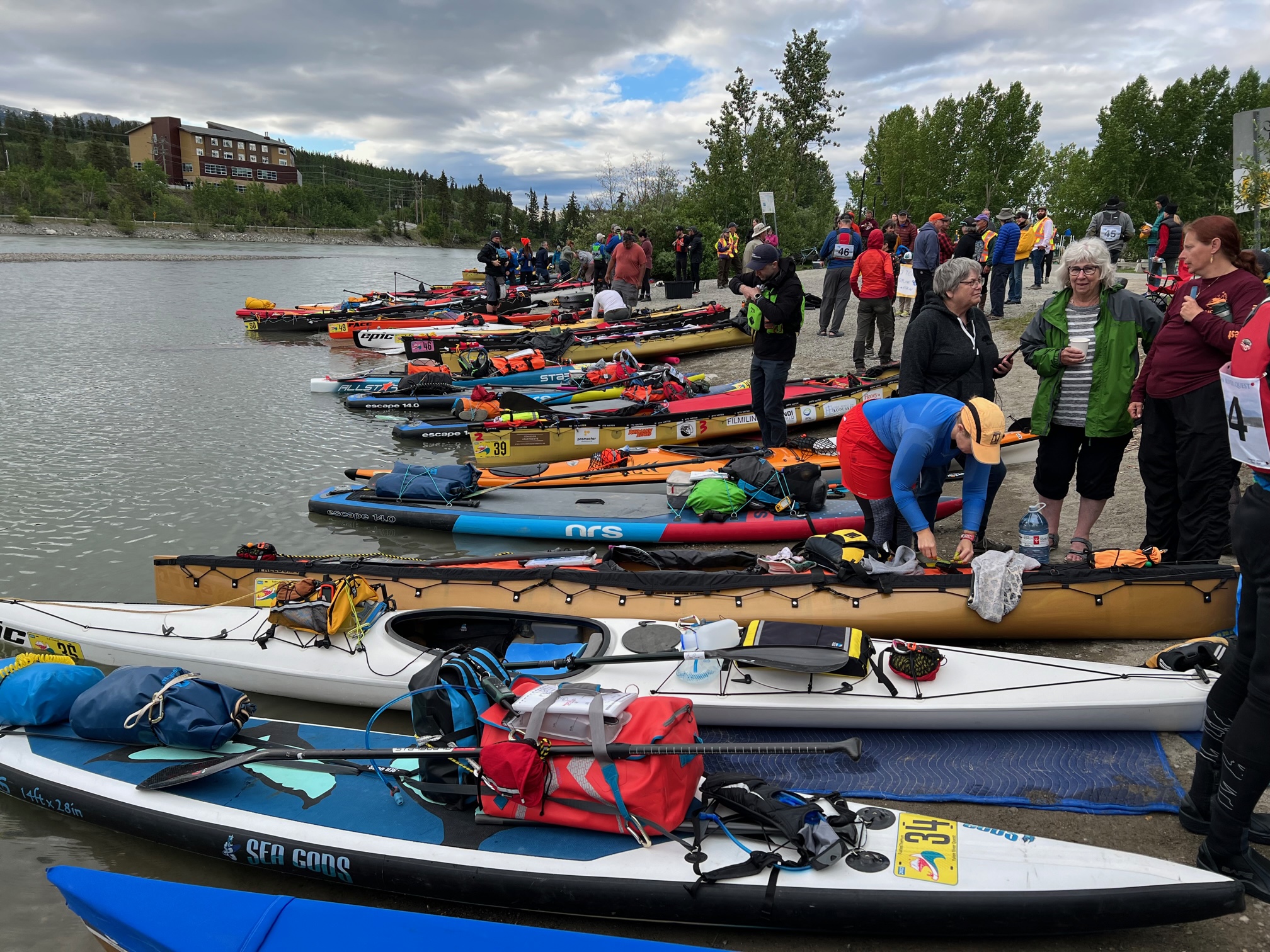 Yukon River Quest row of racing kayaks preparing for start